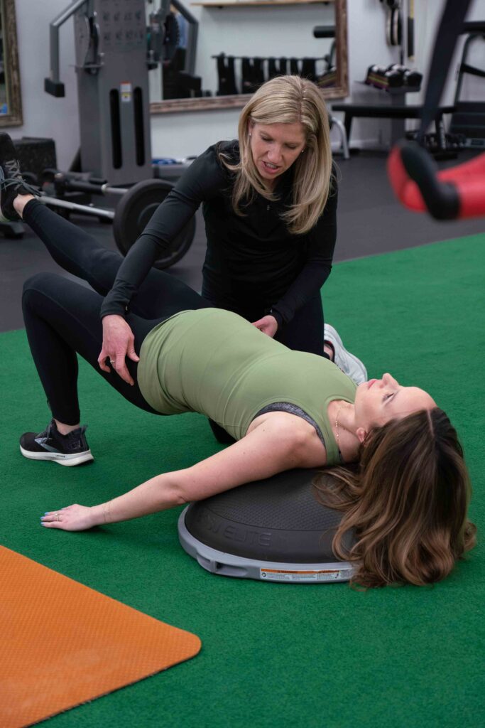  Patient working with a provider during a functional movement assessment at a physical therapy and performance clinic in Williamsville, NY